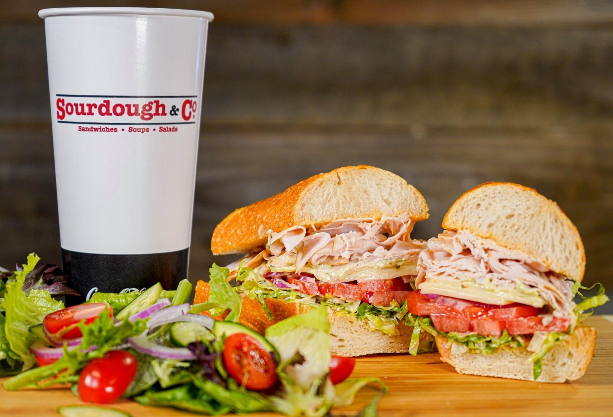 Sourdough & Co. fresh-baked sourdough sandwiches with salad and a branded drink