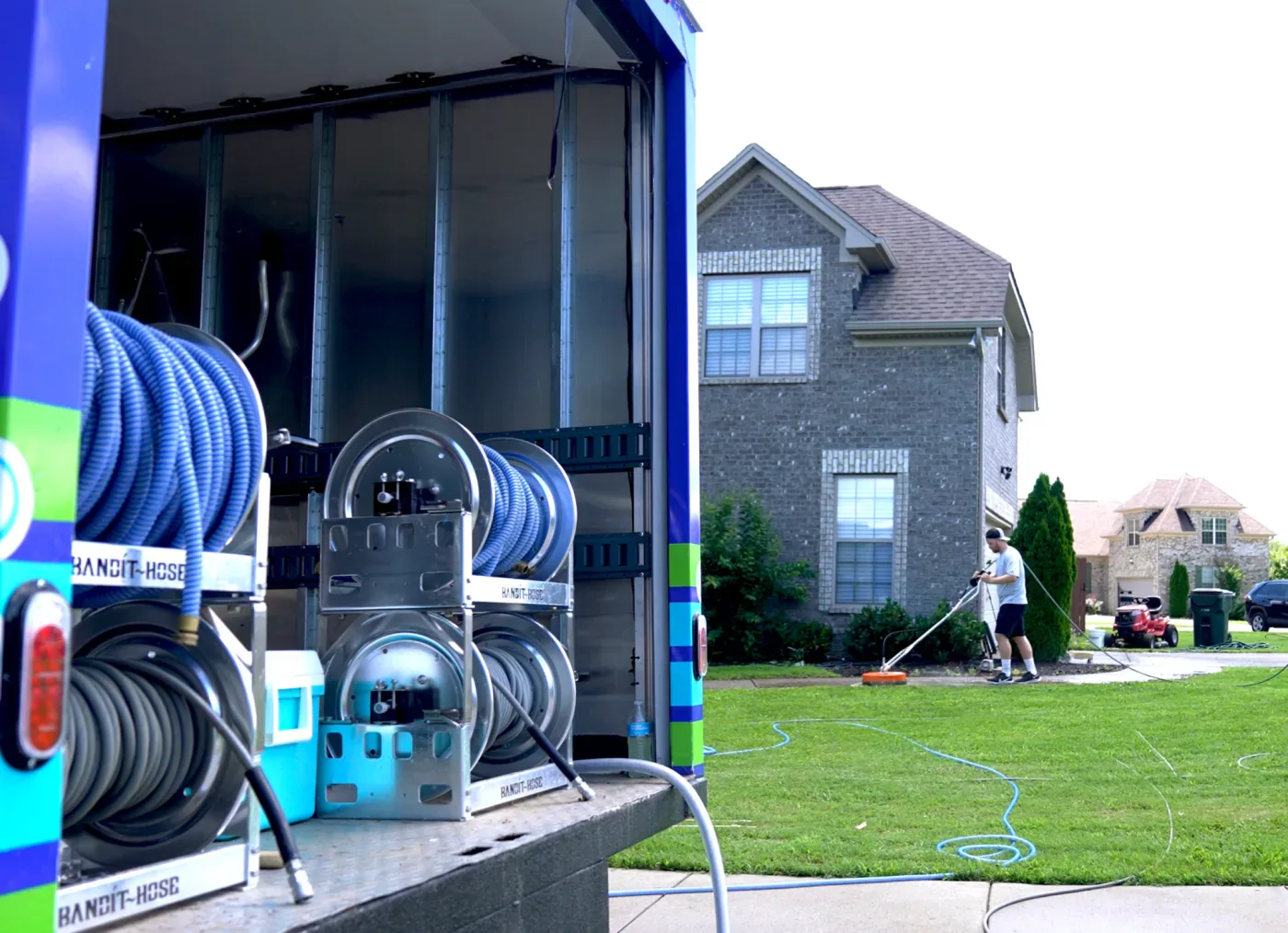 A Rolling Suds power washing truck on a residential job.