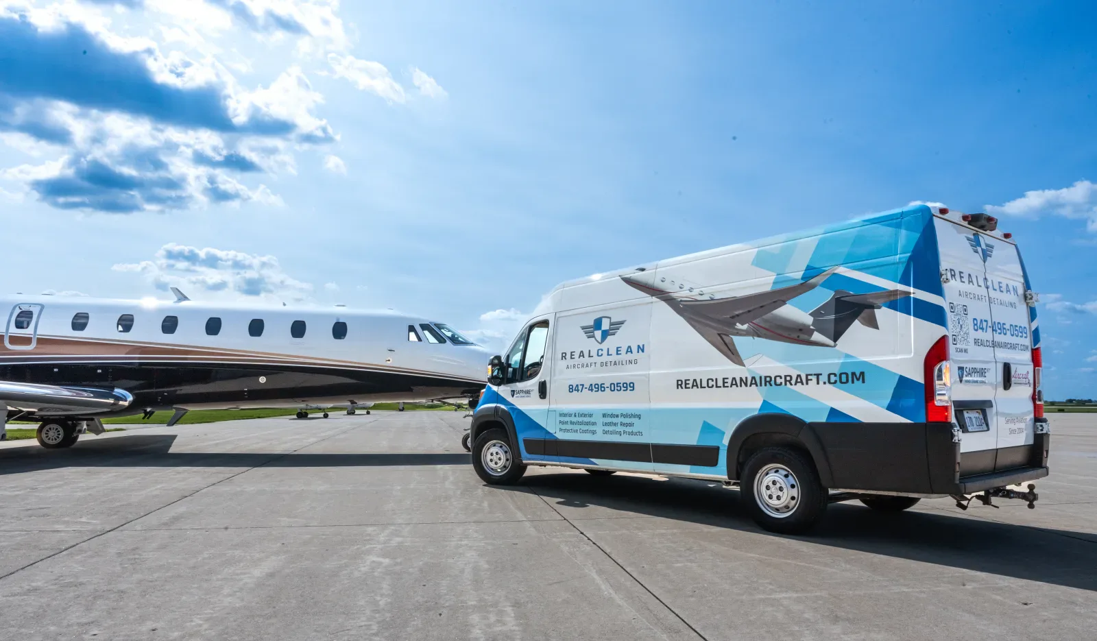 RealClean aircraft detailing van beside a private jet at an airport