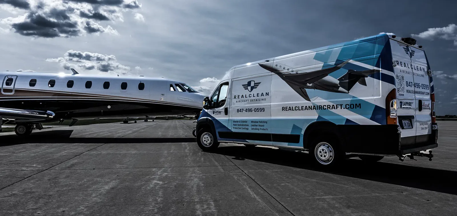 Private jet beside a RealClean aircraft detailing service van