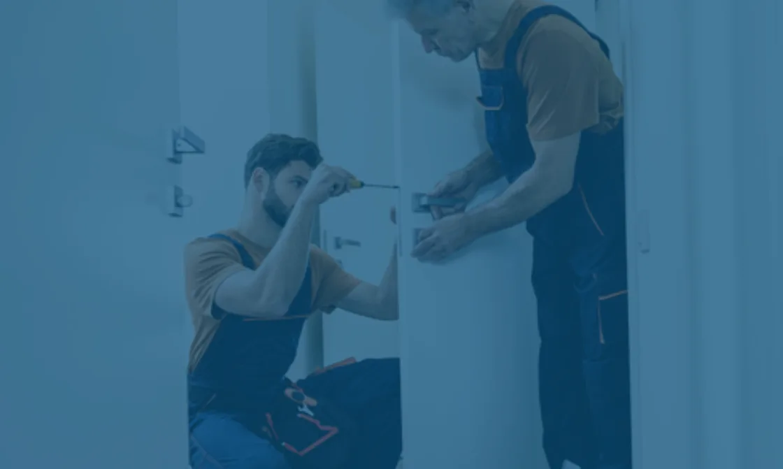 A home service professional completing repairs inside a home.